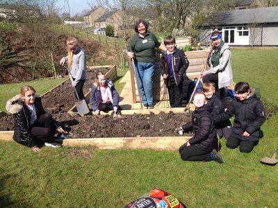 Image of Year 6 create a community allotment and wild flower meadow